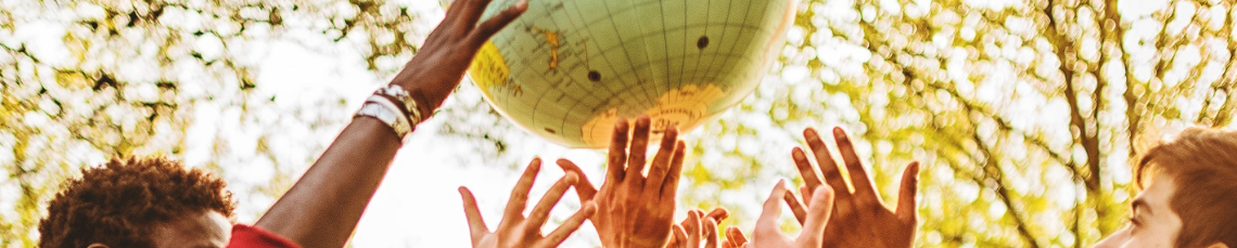 People supporting a globe