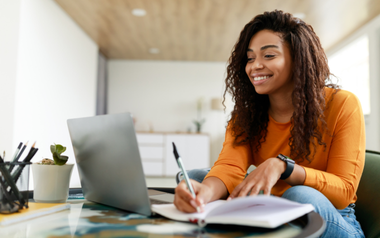 Woman using laptop with headset
